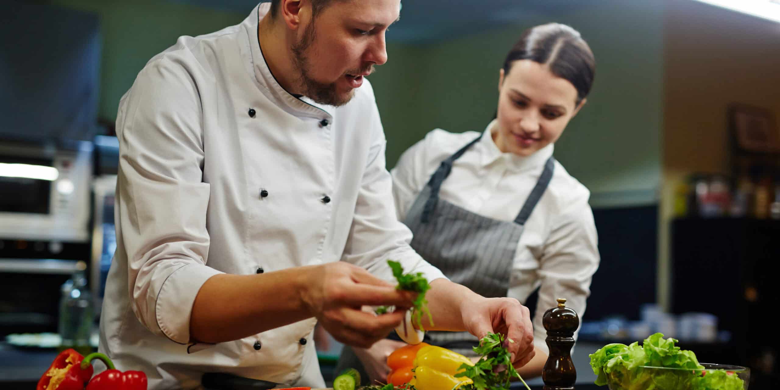 Chef,Consulting,His,Trainee,While,Cooking,Salad Certified cook